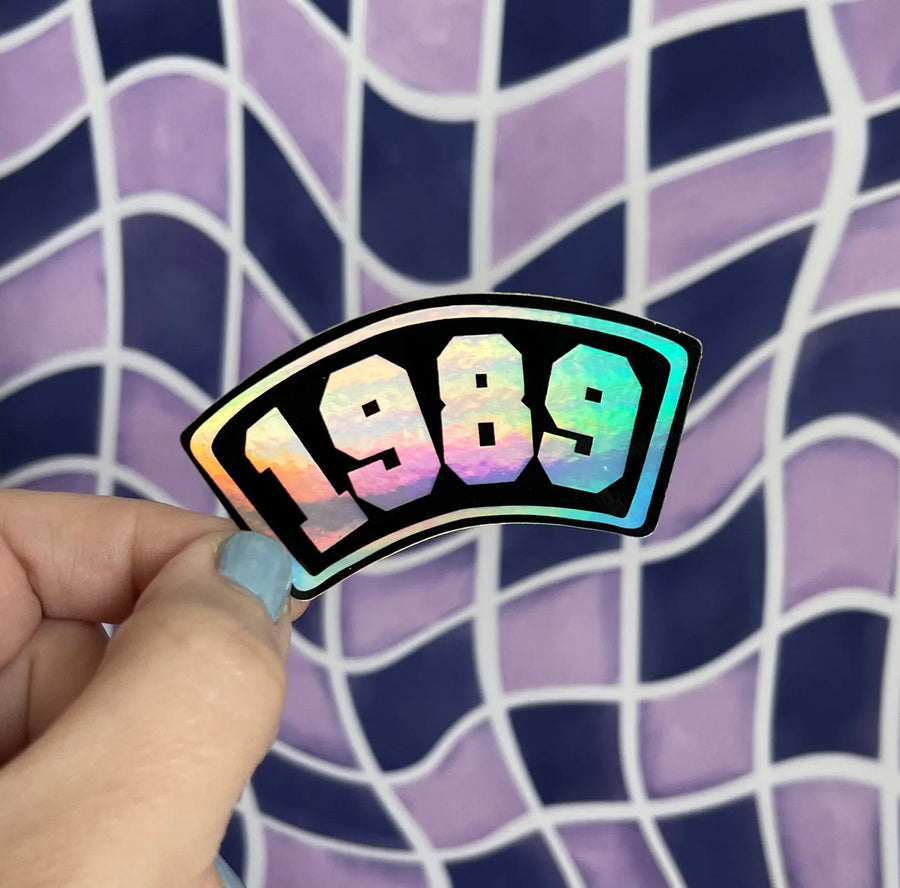 1989 Collegiate black holographic sticker MangoIllustrated