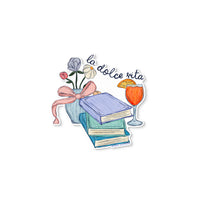 Vinyl sticker with La Dolce Vita design featuring books, flowers in a vase, and an Aperol spritz illustration.