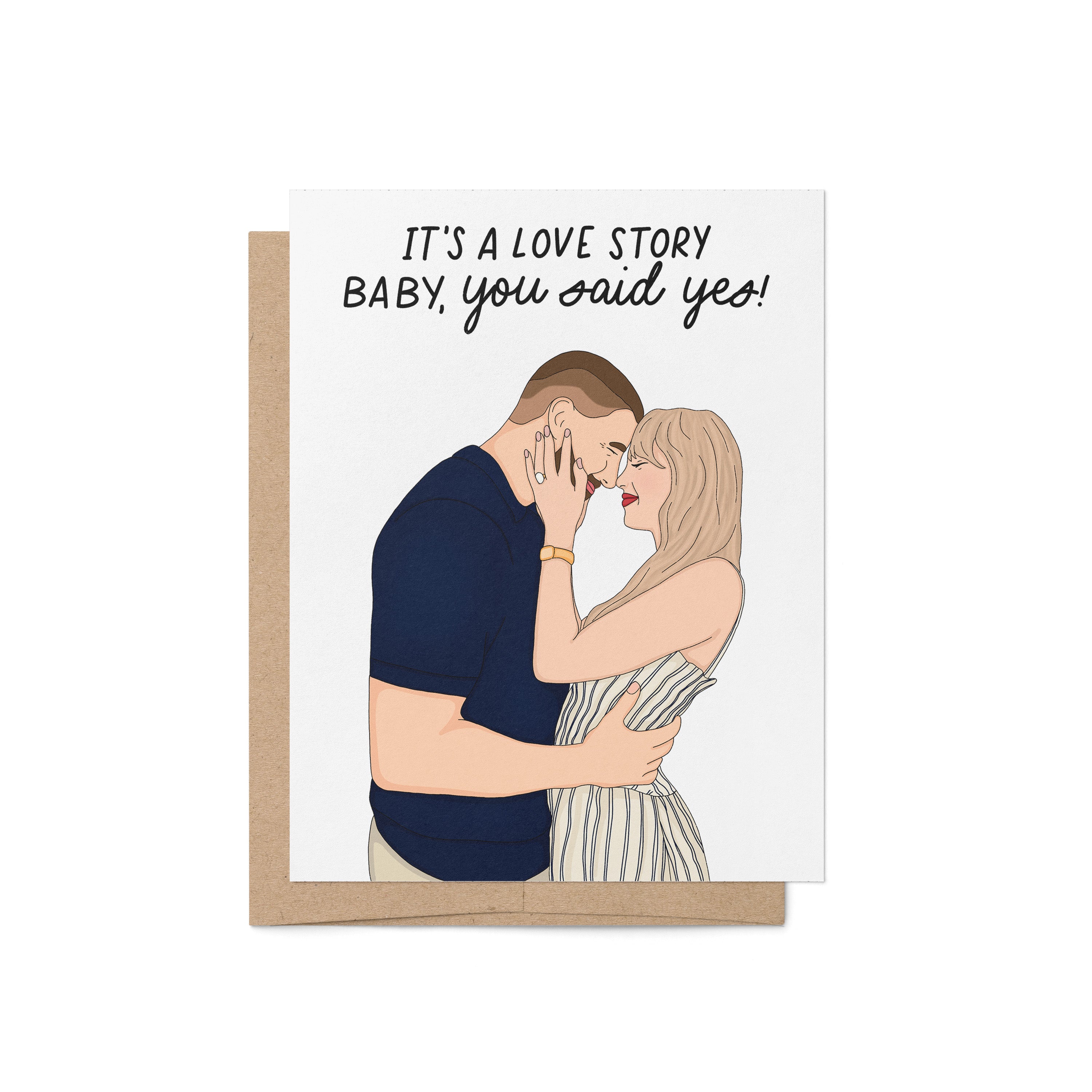 Illustrated engagement card featuring a couple embracing with the caption “It’s a love story baby, you said yes!” above them.