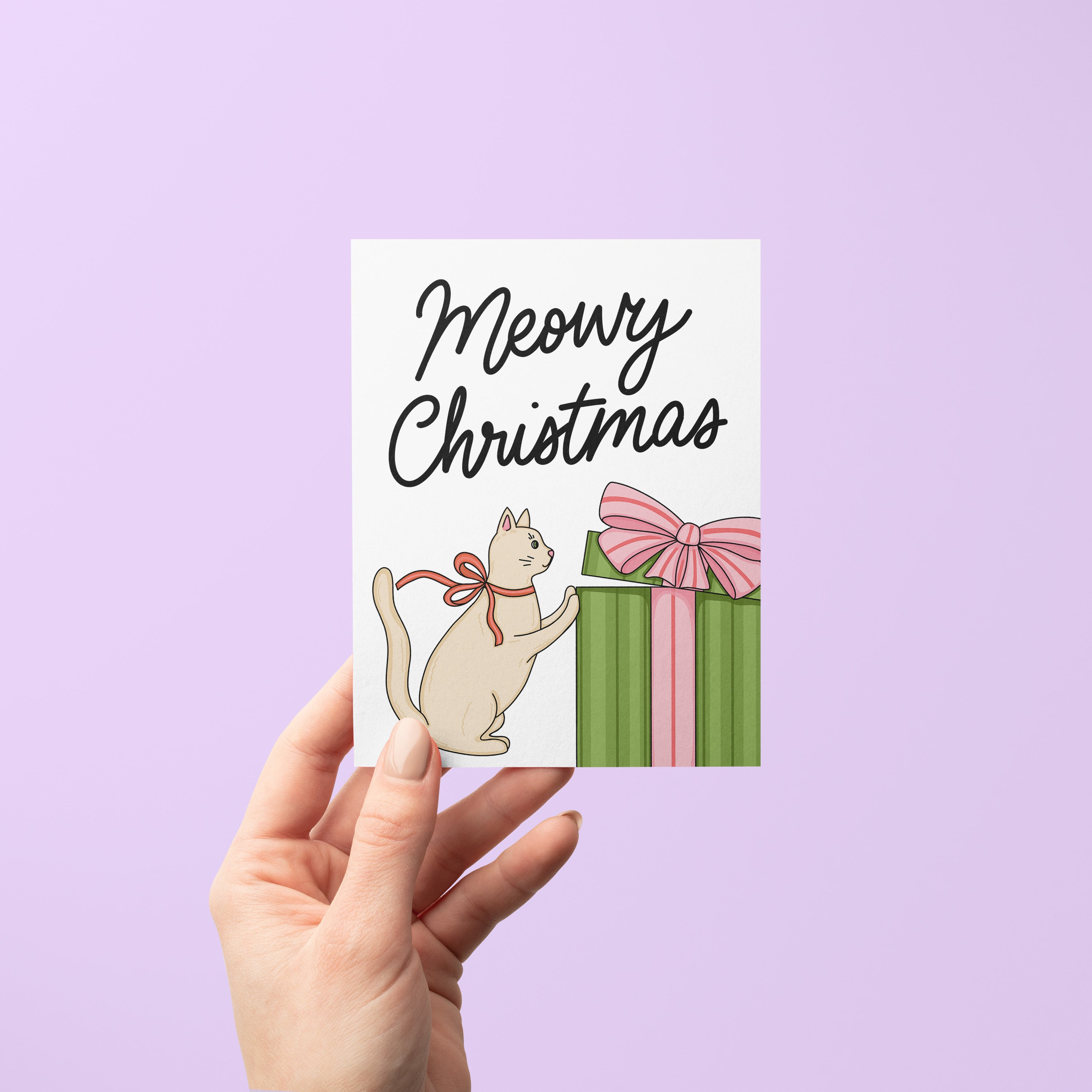 Meowy Christmas card detail — festive cat pawing at present greeting card by MangoIllustrated