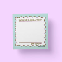 One Thing To Focus On sticky notes flat lay — productivity desk accessory by indie artist MangoIllustrated