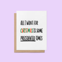 Holiday greeting card with bold black text reading “All I Want For Christmas is Some Precedented Times,” with "Christmas" in festive red and green letters.