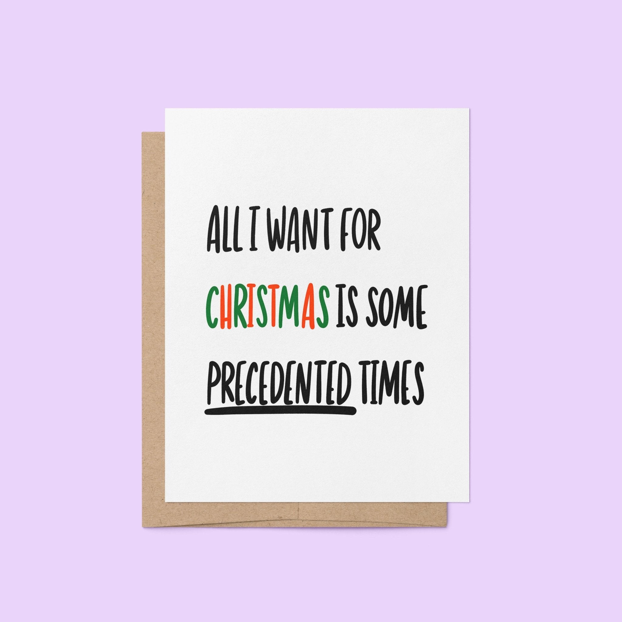 Holiday greeting card with bold black text reading “All I Want For Christmas is Some Precedented Times,” with "Christmas" in festive red and green letters.