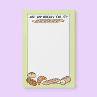 Notepad with green border, bread illustrations (baguette, croissant, loaf), and text “Are You Bready For It?” – cute Swiftie bread-themed stationery gift.