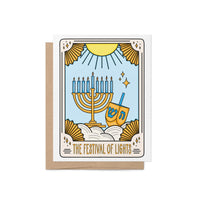 Festival of Lights Hanukkah tarot card style greeting card with tarot-style menorah and dreidel illustration, set against a blue and gold celestial background. Includes kraft envelope.