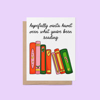 Funny holiday card with illustrated books and the message “Hopefully Santa hasn’t seen what you’ve been reading,” featuring festive book spines in red, green, pink, and orange.