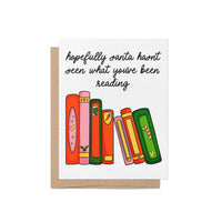 Funny holiday card with illustrated books and the message “Hopefully Santa hasn’t seen what you’ve been reading,” featuring festive book spines in red, green, pink, and orange.