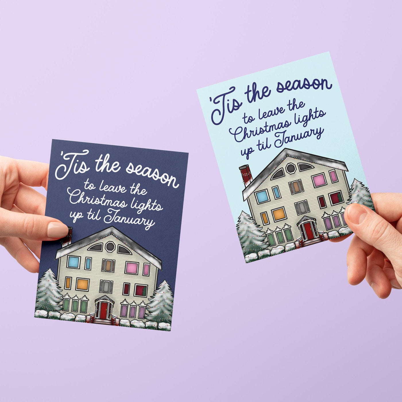 This Swiftie holiday card features an illustration of the Lover House decked out in Christmas lights and dusted with snow. The greeting reads &quot;&#39;Tis the season to leave the Christmas lights up till January.&quot;