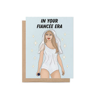 Engagement card with the phrase “In Your Fiancée Era” featuring an illustration of a woman in a sparkling outfit with a bridal veil and microphone.