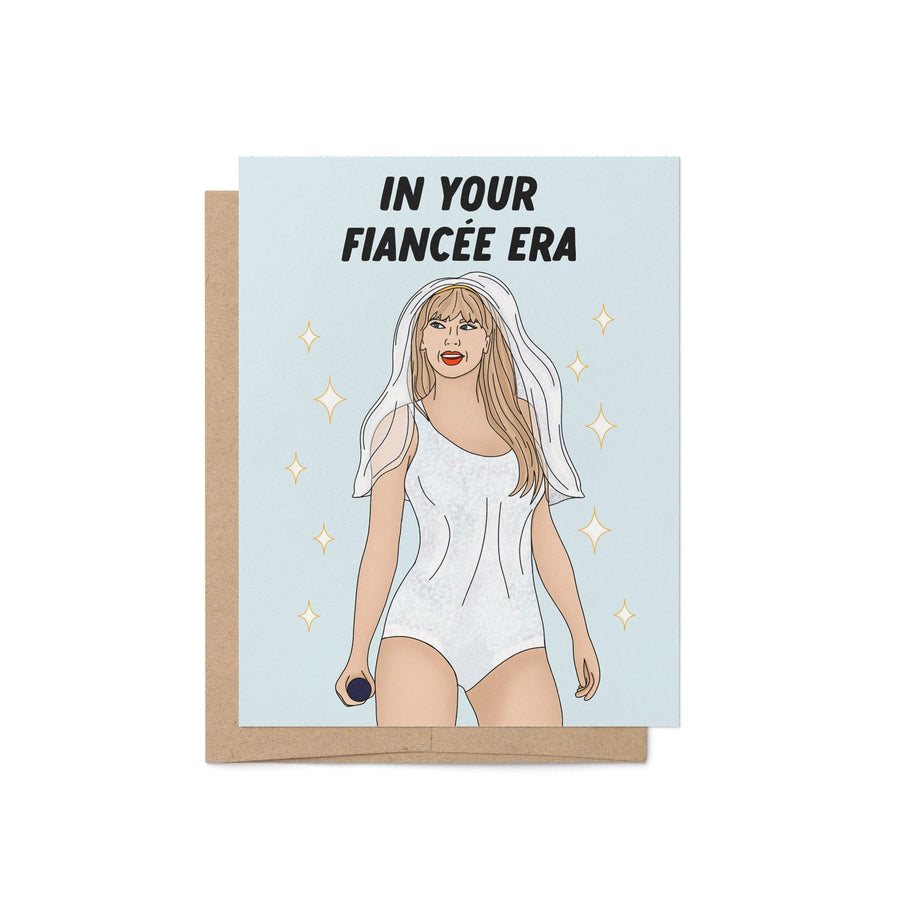 Engagement card with the phrase “In Your Fiancée Era” featuring an illustration of a woman in a sparkling outfit with a bridal veil and microphone.