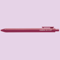 Pink pen with 'Karma is a Cat' text on a light purple background