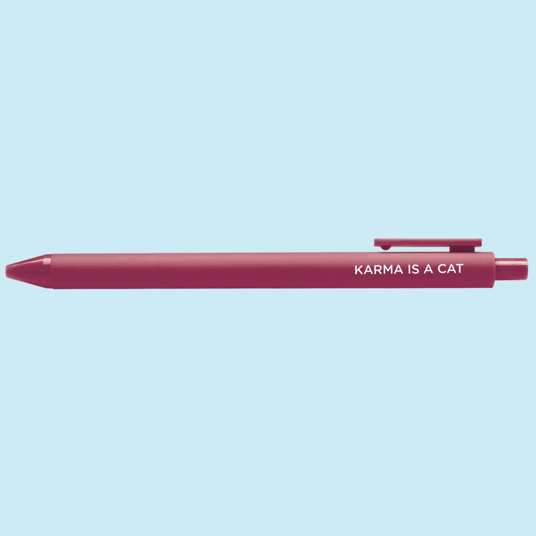 Maroon pen with 'Karma is a Cat' text on a light blue background