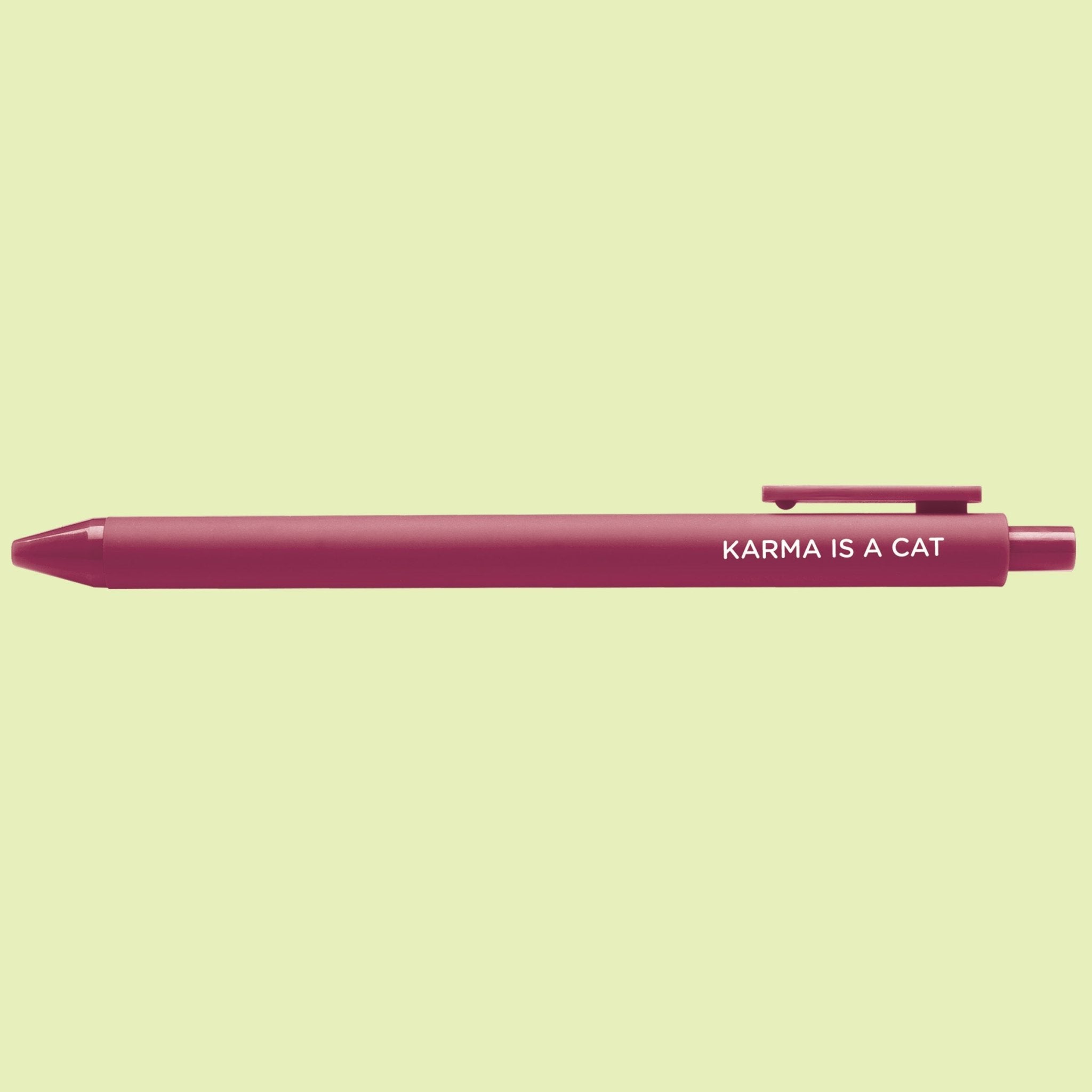 Maroon pen with 'Karma is a Cat' text on a light green background