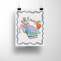 Illustrated art print featuring pastel books, a vase of flowers with a ribbon, and an Aperol spritz with the handwritten text "la dolce vita" on a striped background.