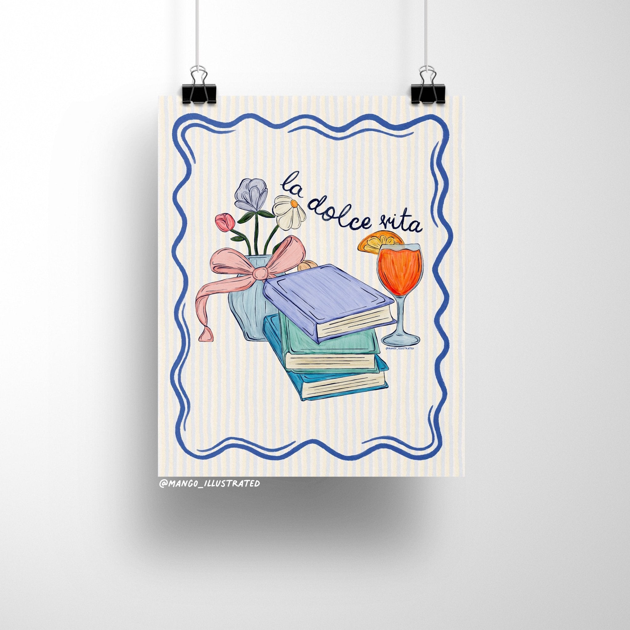 Illustrated art print featuring pastel books, a vase of flowers with a ribbon, and an Aperol spritz with the handwritten text "la dolce vita" on a striped background.