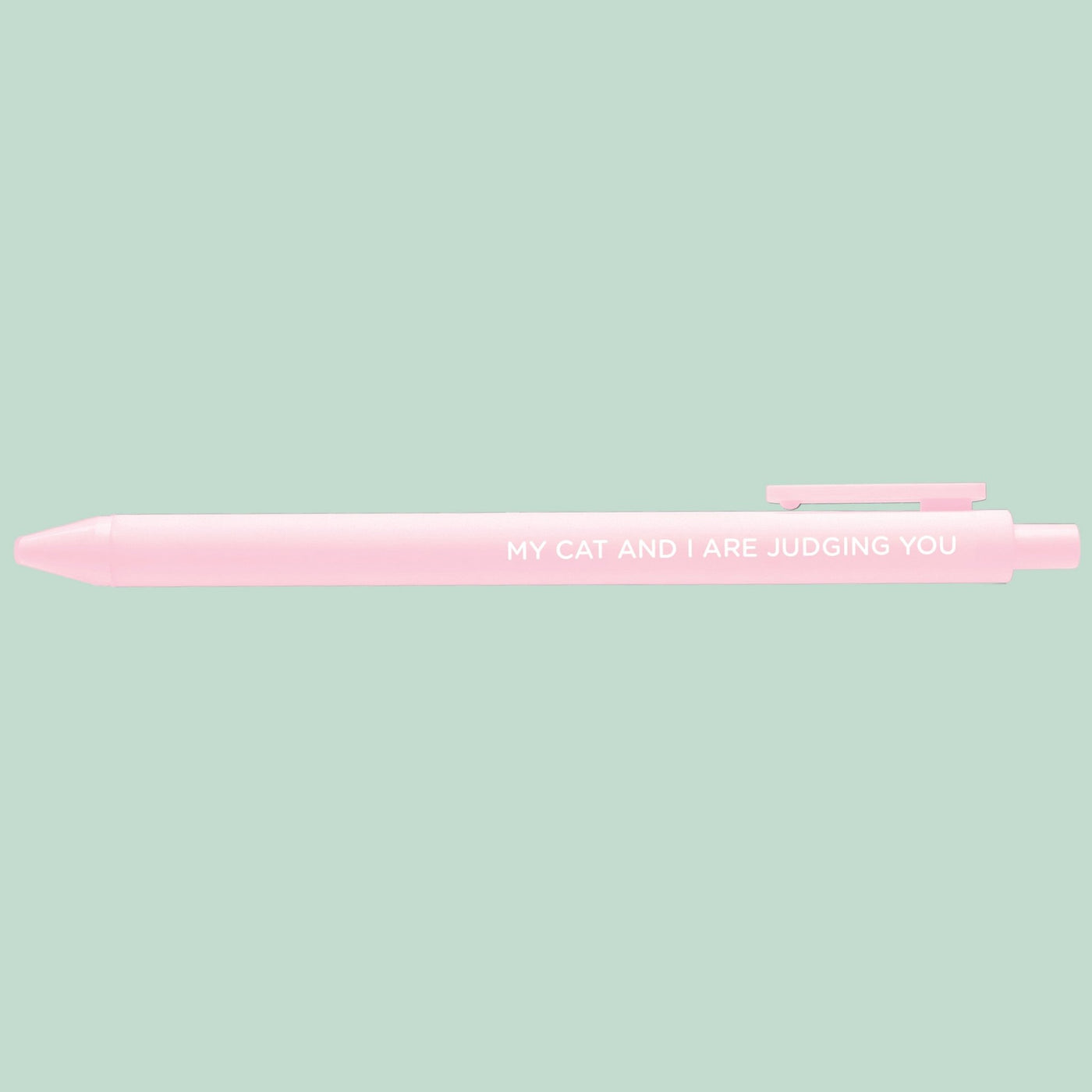 Pink pen with text on a light green background
