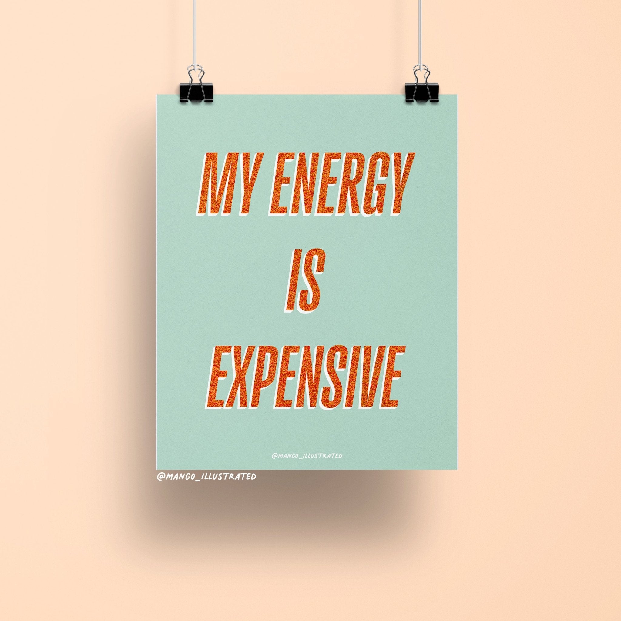8x10 art print with bold orange glitter-style text reading “My Energy is Expensive” on a mint green background, printed on matte paper and packaged with cardboard backing in a cellophane sleeve.