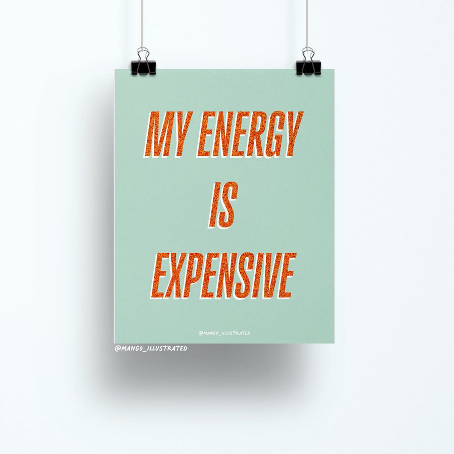 8x10 art print with bold orange glitter-style text reading “My Energy is Expensive” on a mint green background, printed on matte paper and packaged with cardboard backing in a cellophane sleeve.