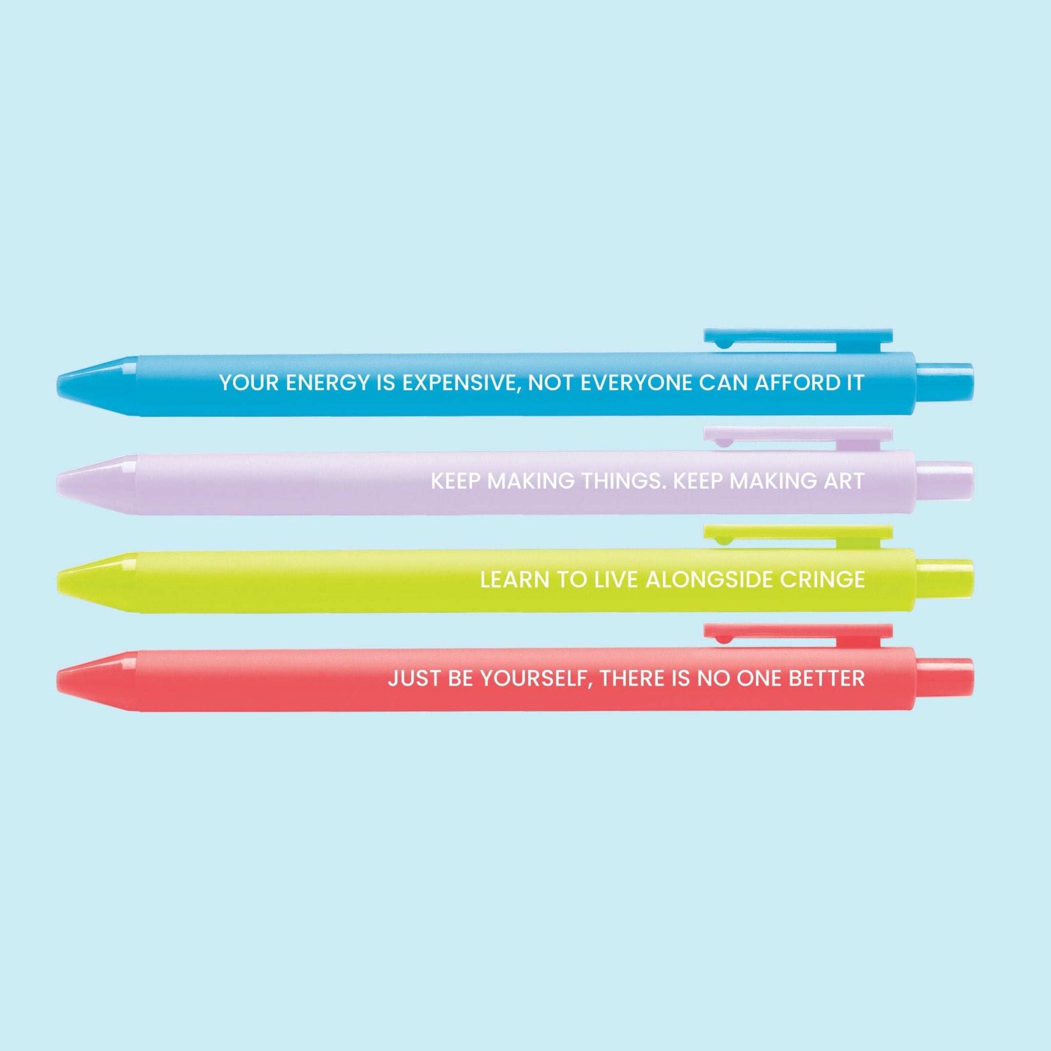 Set of four colorful pens with motivational affirmations, including “Your energy is expensive,” “Keep making art,” “Live alongside cringe,” and “Just be yourself.”