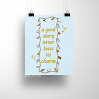8x10 art print with the quote "a good story never loses its charm" surrounded by colorful illustrated charms on a light blue background