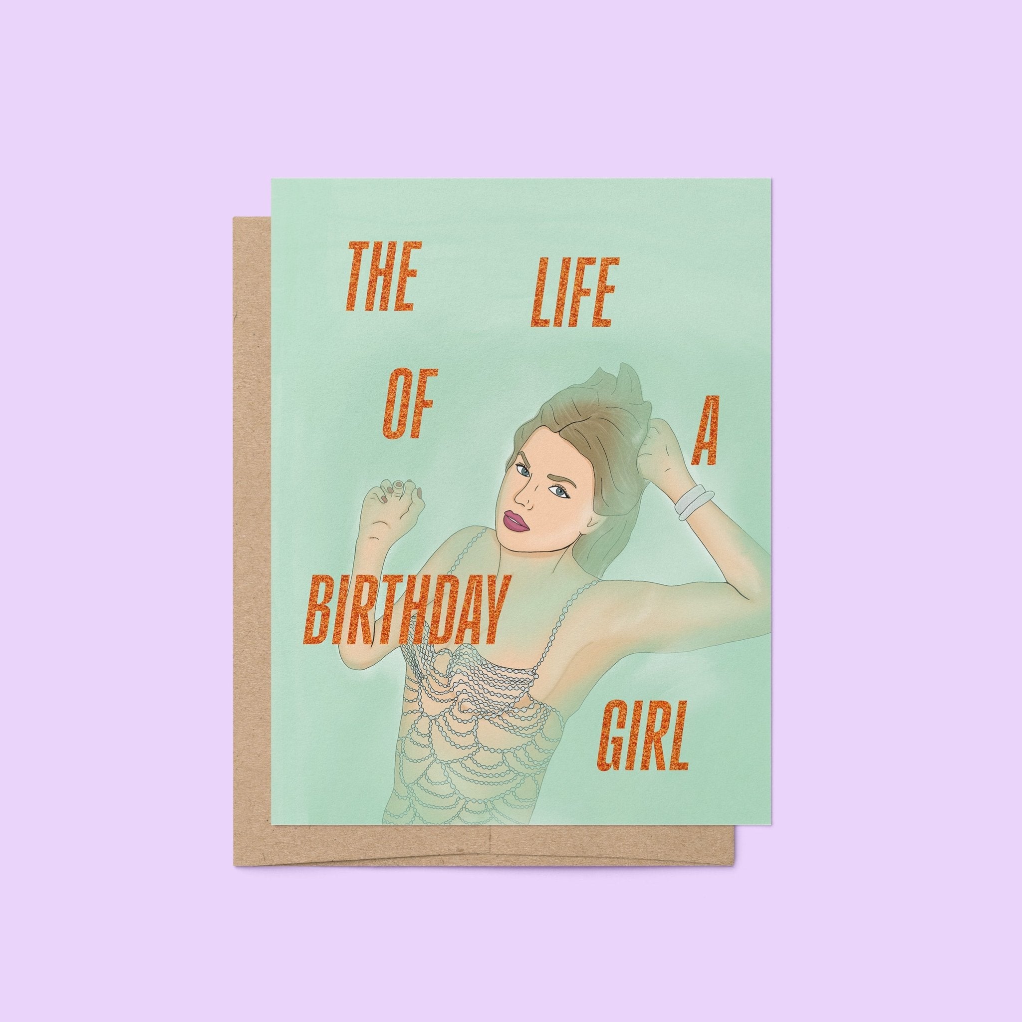 Taylor Swift-inspired birthday card titled “The Life of a Birthday Girl” featuring an illustrated glamorous woman in a sparkling, beaded-style outfit on a mint green background, paired with a kraft envelope.