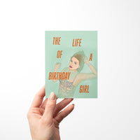 Taylor Swift-inspired birthday card titled “The Life of a Birthday Girl” featuring an illustrated glamorous woman in a sparkling, beaded-style outfit on a mint green background, paired with a kraft envelope.