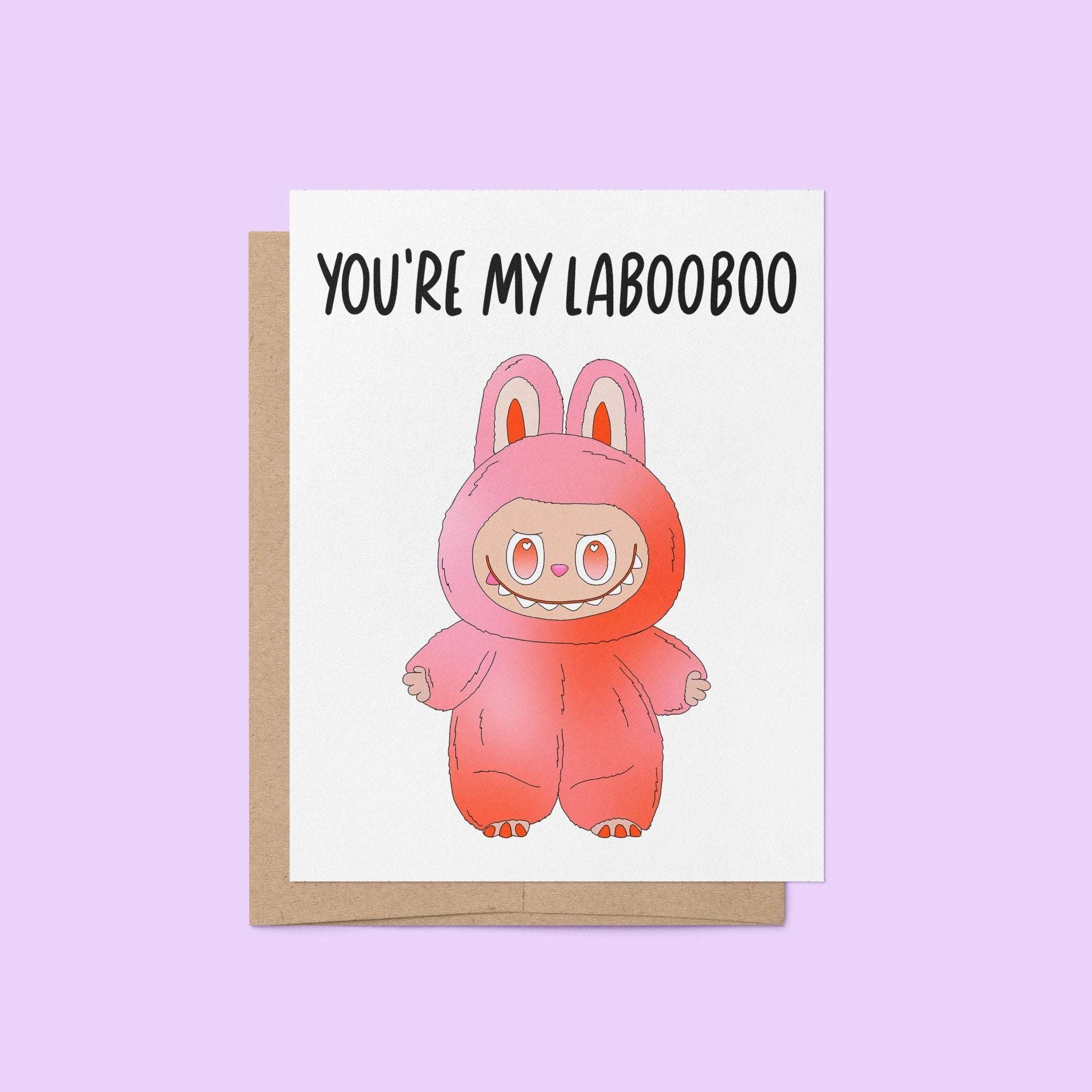 Greeting card with the phrase “You’re My Labooboo” above a cute pink monster illustration, blank inside with kraft envelope.