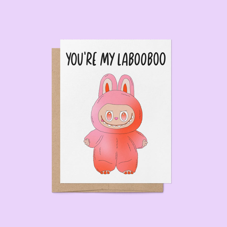 Greeting card with the phrase “You’re My Labooboo” above a cute pink monster illustration, blank inside with kraft envelope.