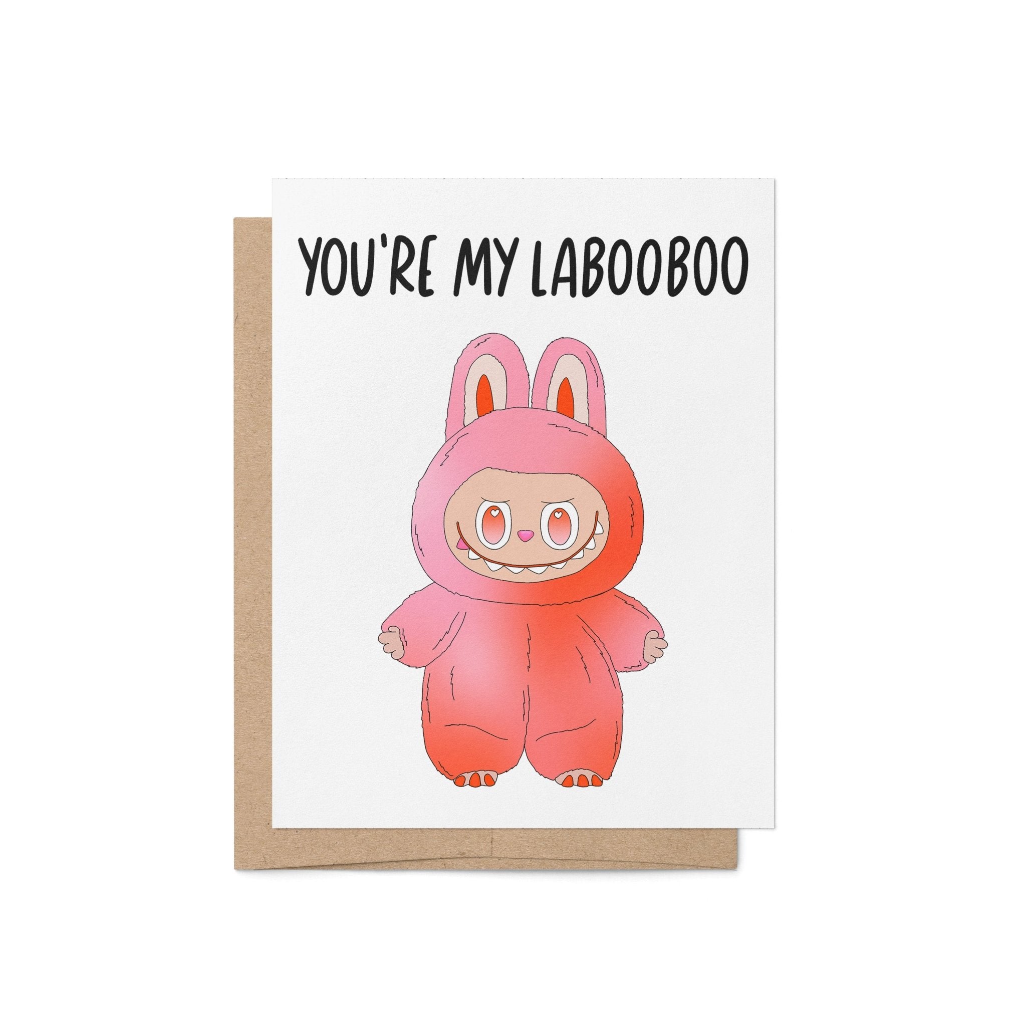 Greeting card with the phrase “You’re My Labooboo” above a cute pink monster illustration, blank inside with kraft envelope.